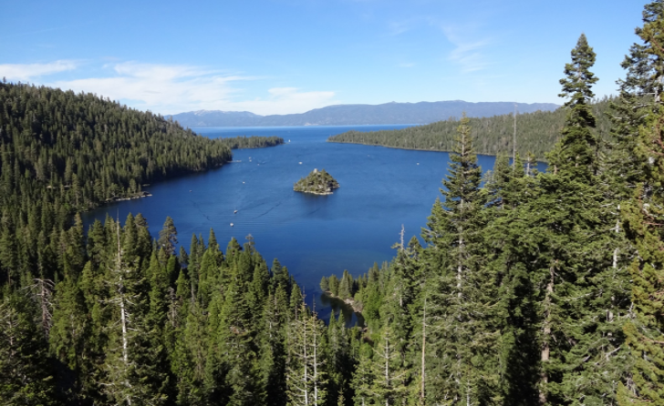 Photo of Emerald Bay on Lake Tahoe with pine trees surrounding the bay and a small island in the center
