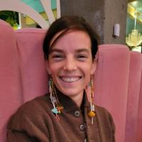 Photo of Boo Curry sitting in a pink booth